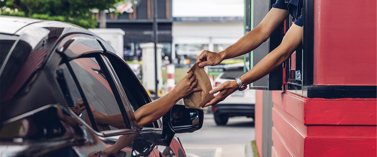 Drive Thru with operator handing customer food